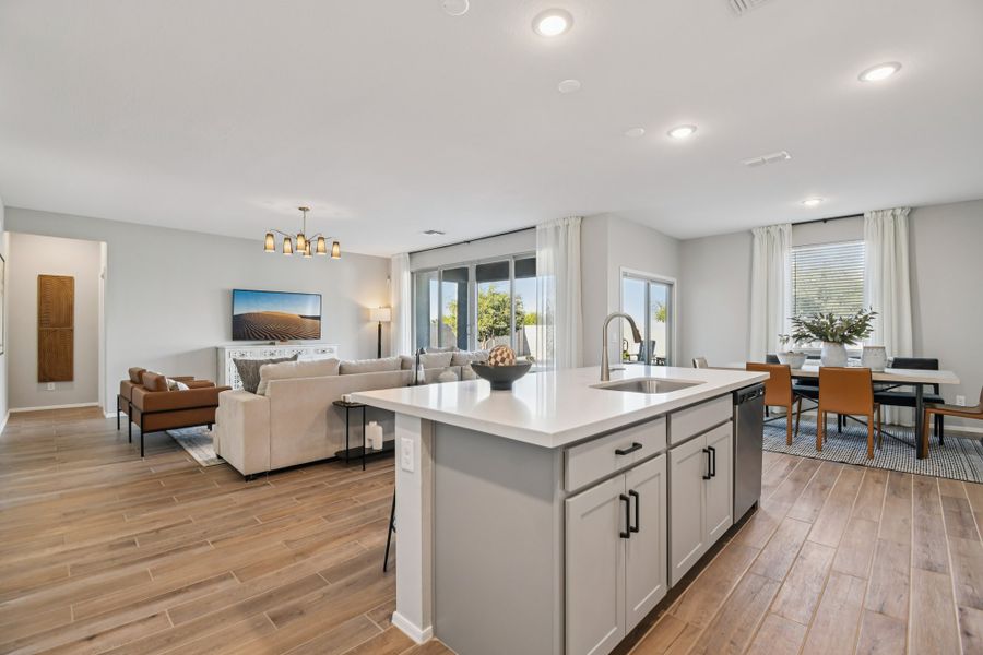 Kitchen with great room and dining nook. Finishes and options may vary by community.