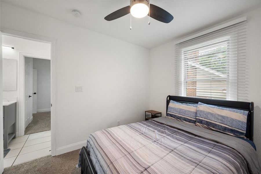Bedroom featuring light carpet and ceiling fan Bedroom featuring light carpet and ceiling fan