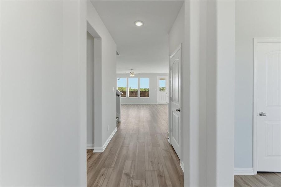 Corridor featuring light wood-style flooring and recessed lighting