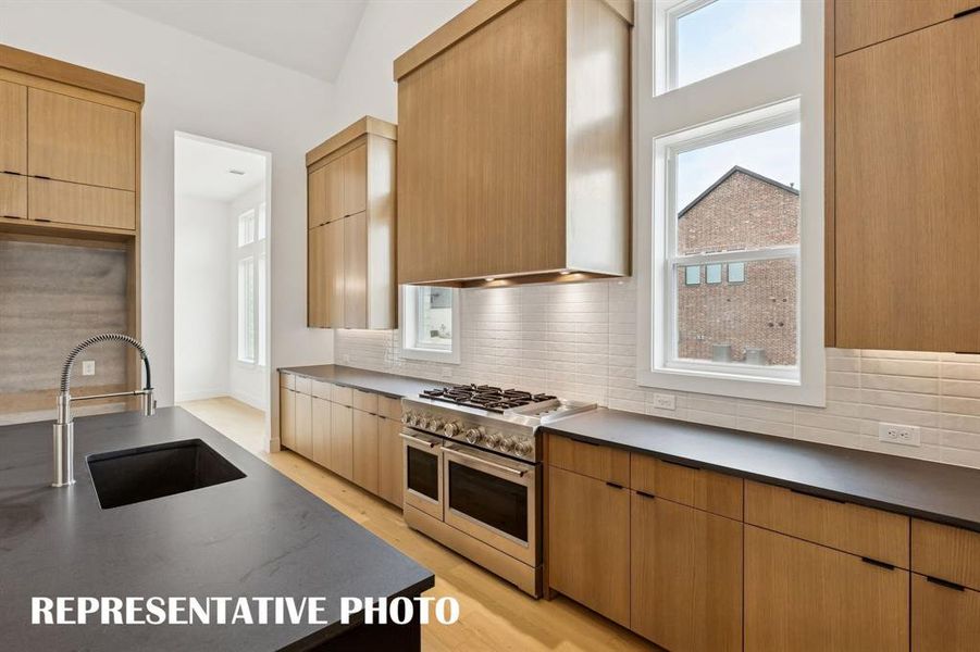 Top of the line appliances, beautiful cabinetry, impressive counter tops....this dream kitchen is one for the ages!  REPRESENTATIVE PHOTO