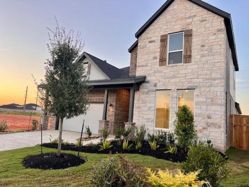 Front exterior of a new home in Cross Creek West: Richmond Collection, Fulshear, TX, highlighting curb appeal (Image 2).