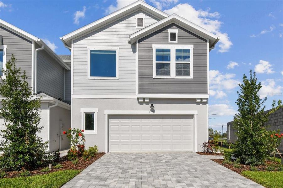 Front exterior of a new home in North River Ranch – Townhomes, Parrish, FL, highlighting curb appeal (Image 1).