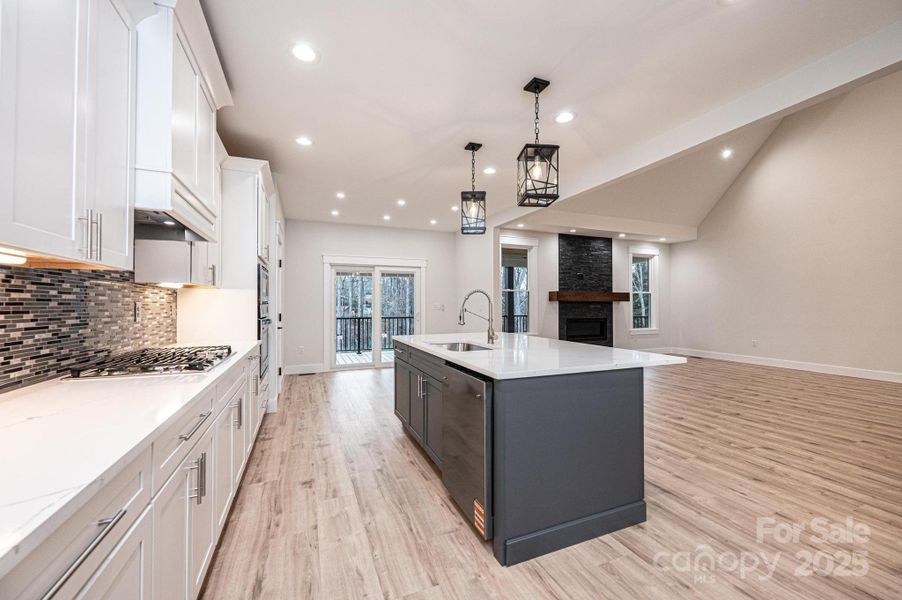 Large Kitchen Island with Breakfast Bar, Sink, Open Floor plan to 2-story Great Room with FireplaceCabinets are white with soft close drawers.. Large Kitchen Island with Breakfast Bar, Sink, Open Floor plan to 2-story Great Room with FireplaceCabinets are white with soft close drawers..