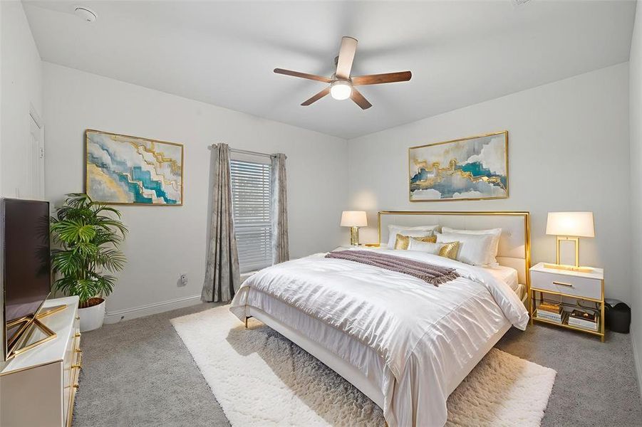 Bedroom with carpet floors and a ceiling fan Bedroom with carpet floors and a ceiling fan