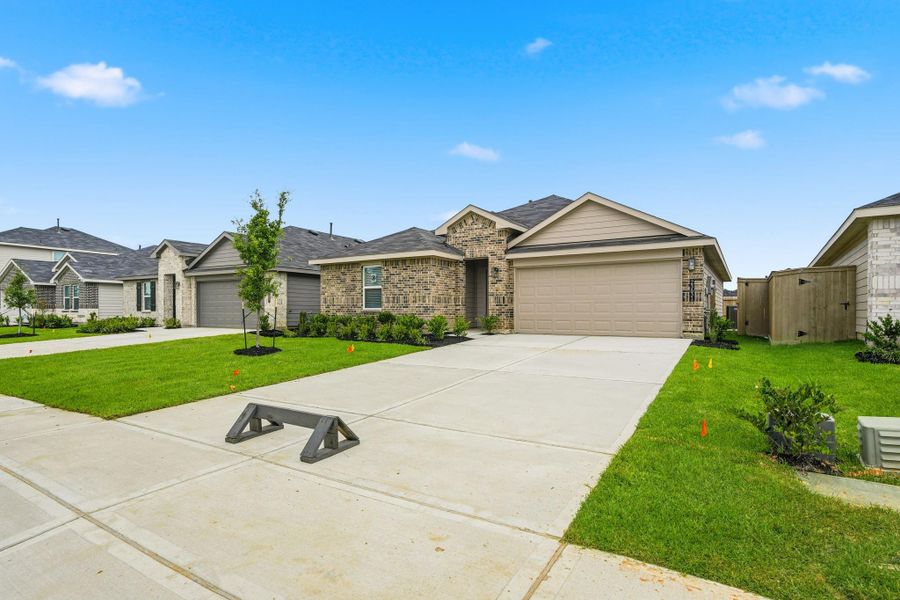 Front exterior of a new home in The Canopies, Splendora, TX, highlighting curb appeal (Image 2). Front exterior of a new home in The Canopies, Splendora, TX, highlighting curb appeal (Image 2).