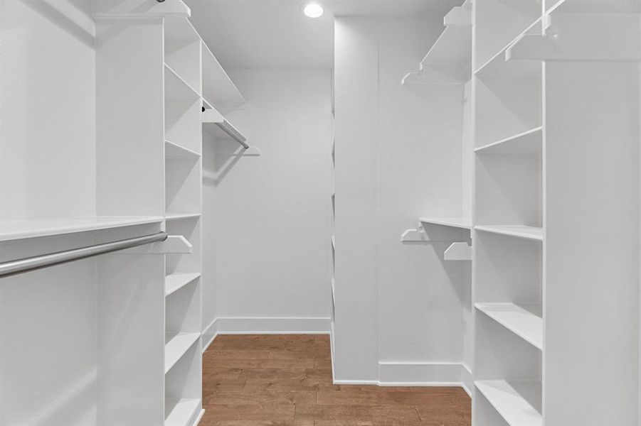 Walk in closet with hardwood / wood-style flooring Walk in closet with hardwood / wood-style flooring
