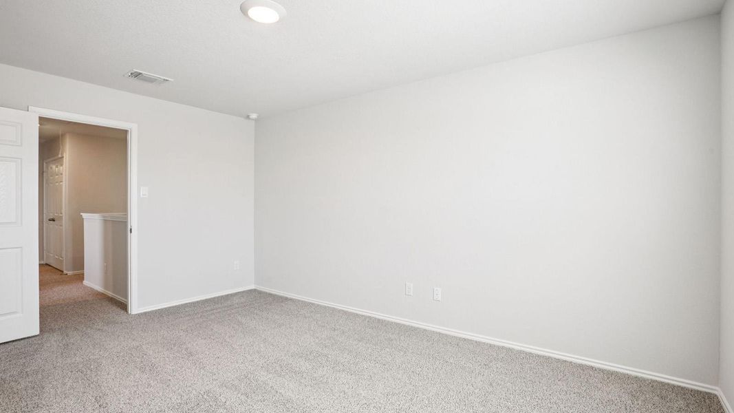 Carpeted room with light neutral walls, white baseboards, and a flush-mount ceiling light fixture