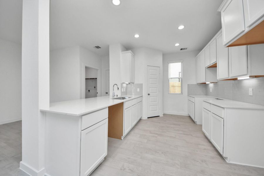 The open concept effortlessly connects the kitchen to the expansive family room, forming a perfect hub for gatherings. This seamless flow creates an inviting space where cooking and socializing come together harmoniously. Sample photo of completed home with similar floor plan. Actual colors and selections may vary.