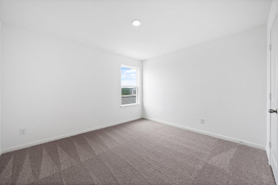 Spare room with baseboards and carpet floors