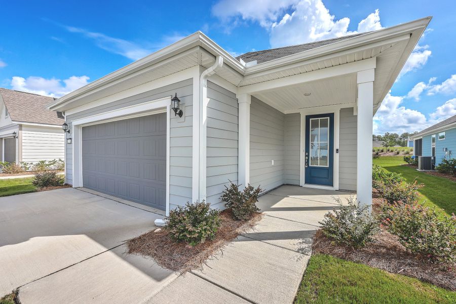 Front exterior of a new home in Del Webb Charleston at Nexton, Summerville, SC, highlighting curb appeal (Image 2). Front exterior of a new home in Del Webb Charleston at Nexton, Summerville, SC, highlighting curb appeal (Image 2).