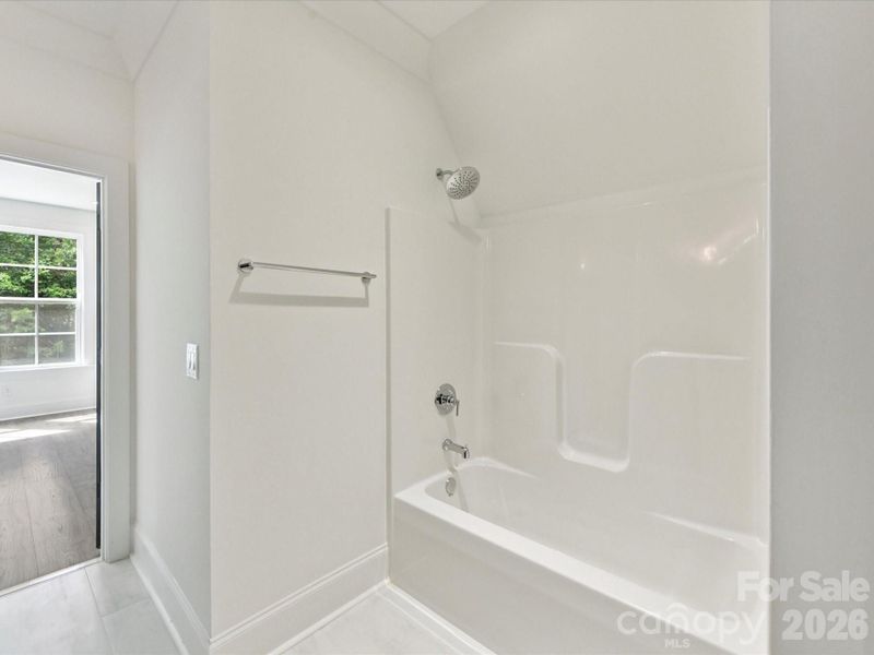 Jack-and-Jill bathroom with double vanity, modern finishes, and convenient access between adjoining bedrooms.