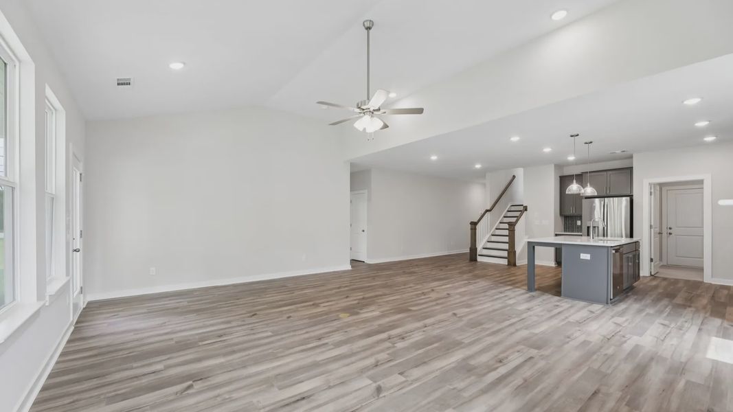 View of kitchen, gathering room, and staircase