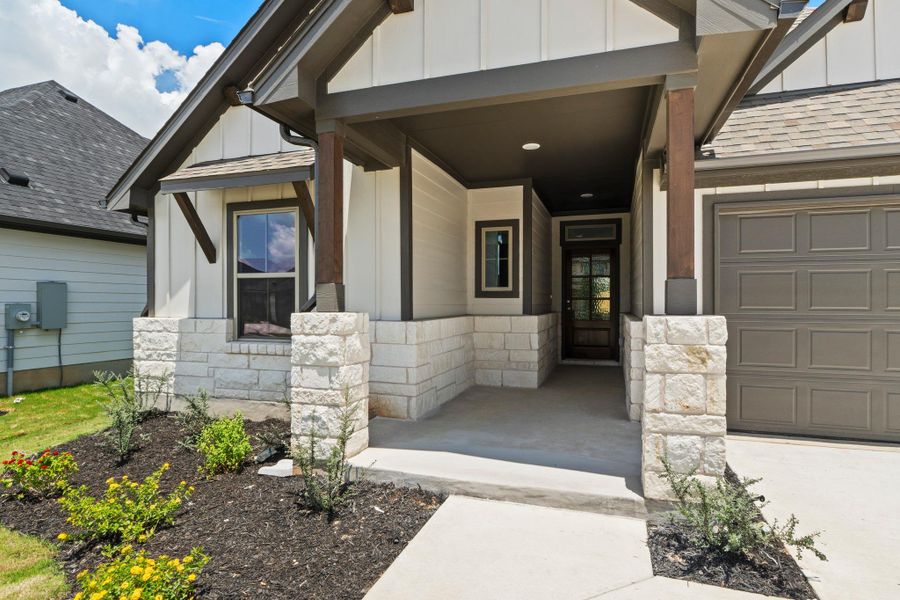 Crafted with board and batten siding and stone accents, this home presents inviting curb appeal.
