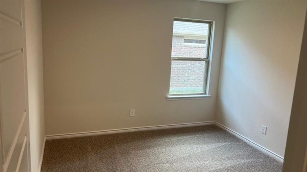 Spare room with carpet flooring and baseboards Spare room with carpet flooring and baseboards