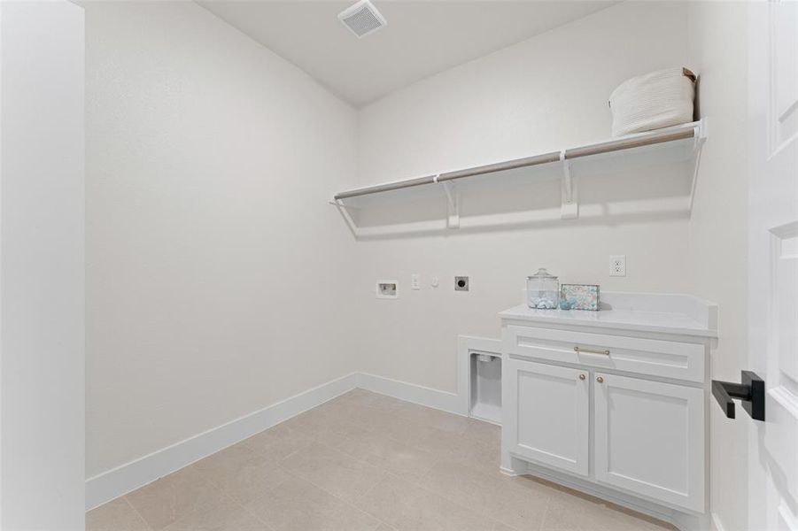 Washroom featuring electric dryer hookup, hookup for a washing machine, baseboards, and light tile patterned floors Washroom featuring electric dryer hookup, hookup for a washing machine, baseboards, and light tile patterned floors