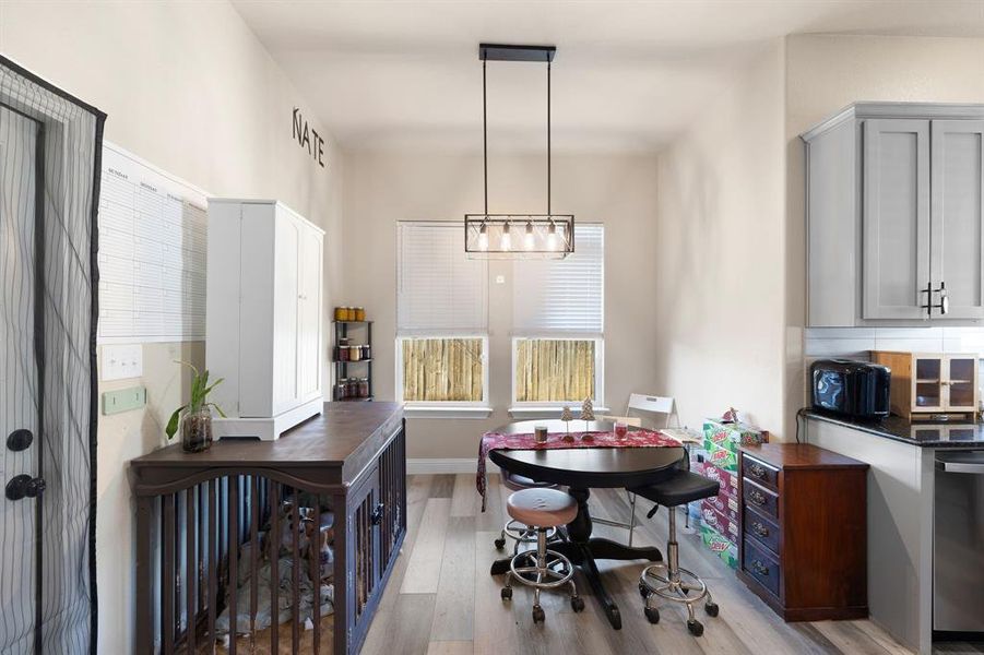 Dining area with light hardwood / wood-style flooring