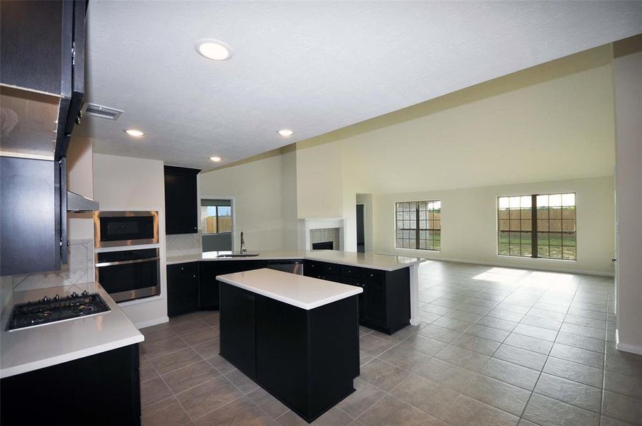 Enjoy the Espresso cabinetry in this bright and cheerful island kitchen.