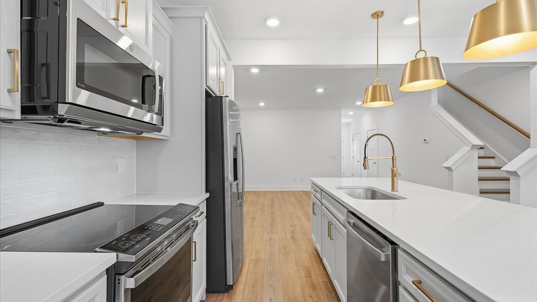 Beautifully appointed kitchen with spacious counters and sophisticated detailing at Clayton Crossing