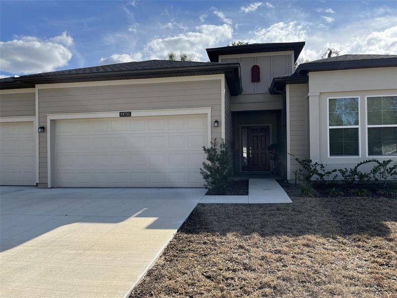 Front exterior of a new home in Grand Park North, Dunnellon, FL, highlighting curb appeal (Image 20).