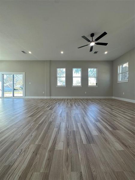 Empty room featuring ceiling fan and light wood-type flooring