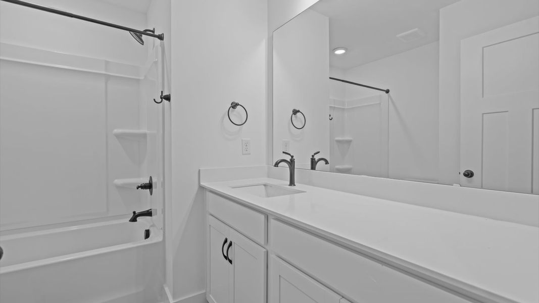 First-rate full bath featuring modern surfaces and a fresh, current color palette First-rate full bath featuring modern surfaces and a fresh, current color palette