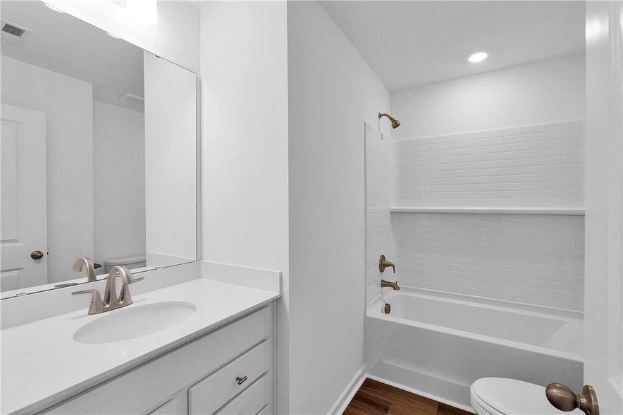 This clean bathroom features a sleek vanity and a