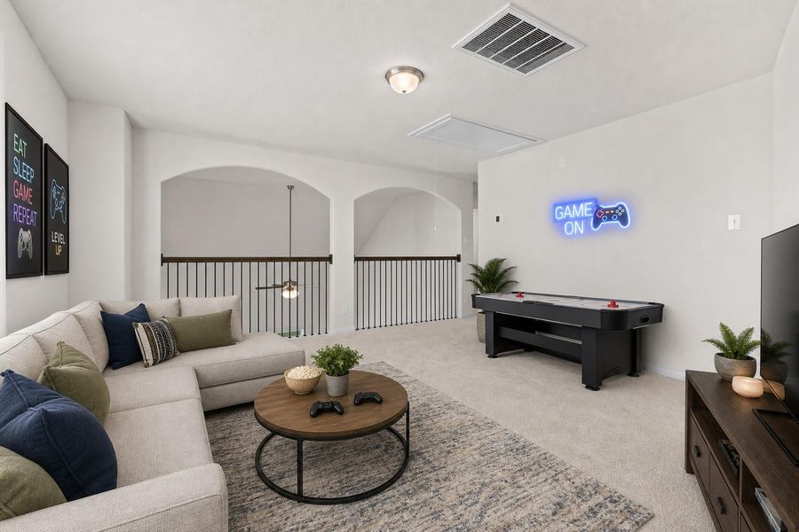 Another view of the upstairs game room highlighting the large open layout and the beautiful railing that overlooks the main living area below. This flexible space is perfect for a media room, play area, or additional family gathering space. *Photo is Virtually Staged*