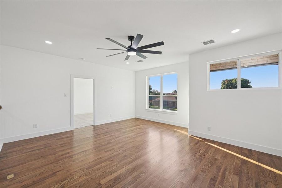Spare room featuring dark wood-style flooring, recessed lighting, and a ceiling fan