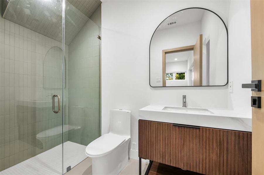 Full bath with a stall shower and vanity