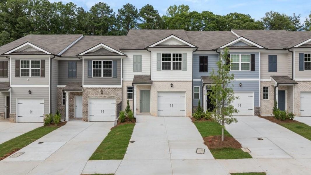 Front exterior of a new home in Woodbury Park, South Fulton, GA, highlighting curb appeal (Image 1). Front exterior of a new home in Woodbury Park, South Fulton, GA, highlighting curb appeal (Image 1).