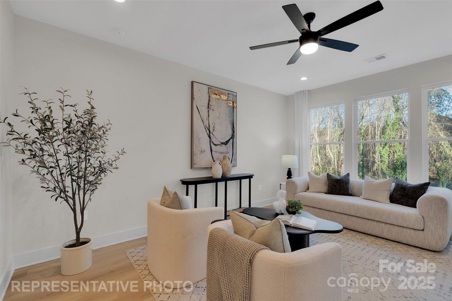 Large windows viewing the gently sloping yard and woods beyond.