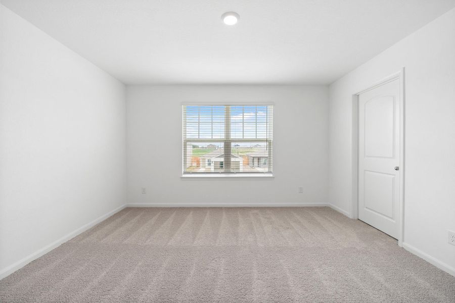 Unfurnished room with light colored carpet and baseboards