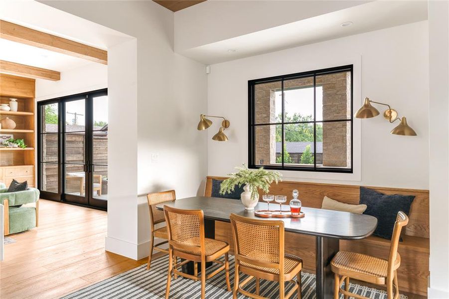 Dining area featuring wood finished floors and beamed ceiling