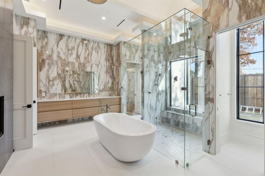 Bathroom with tile walls, vanity, a marble finish shower, a soaking tub, and tile patterned floors