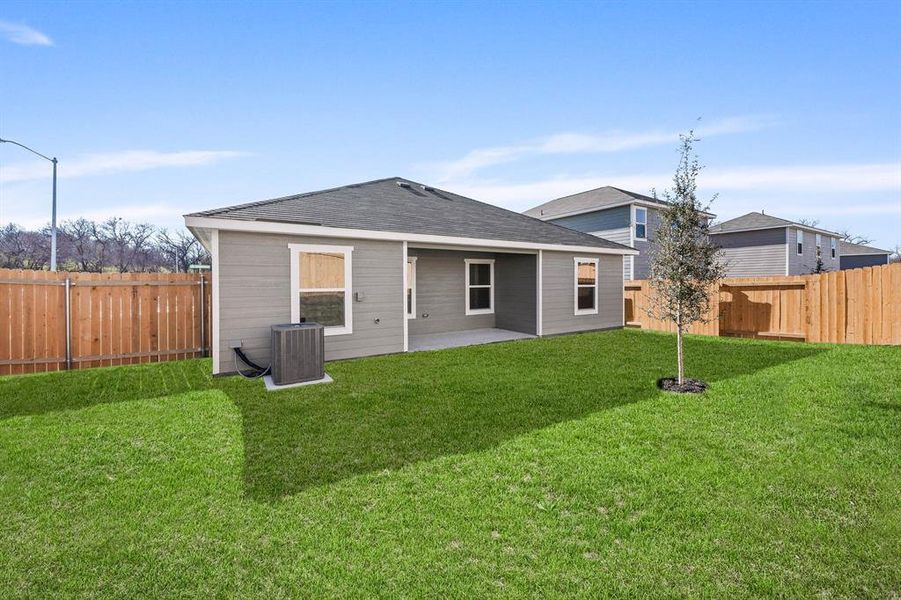 Rear view of house featuring cooling unit, a yard, and a patio
