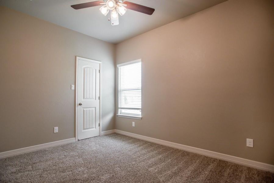 Spare room featuring ceiling fan and carpet floors Spare room featuring ceiling fan and carpet floors