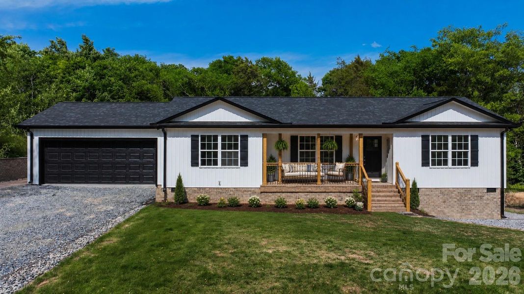 Front of home with 2 car attached garage. Virtual landscape