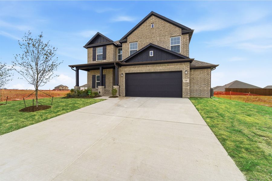 Front exterior of a new home in Saddlebrook Estates, Waxahachie, TX, highlighting curb appeal (Image 26). Front exterior of a new home in Saddlebrook Estates, Waxahachie, TX, highlighting curb appeal (Image 26).