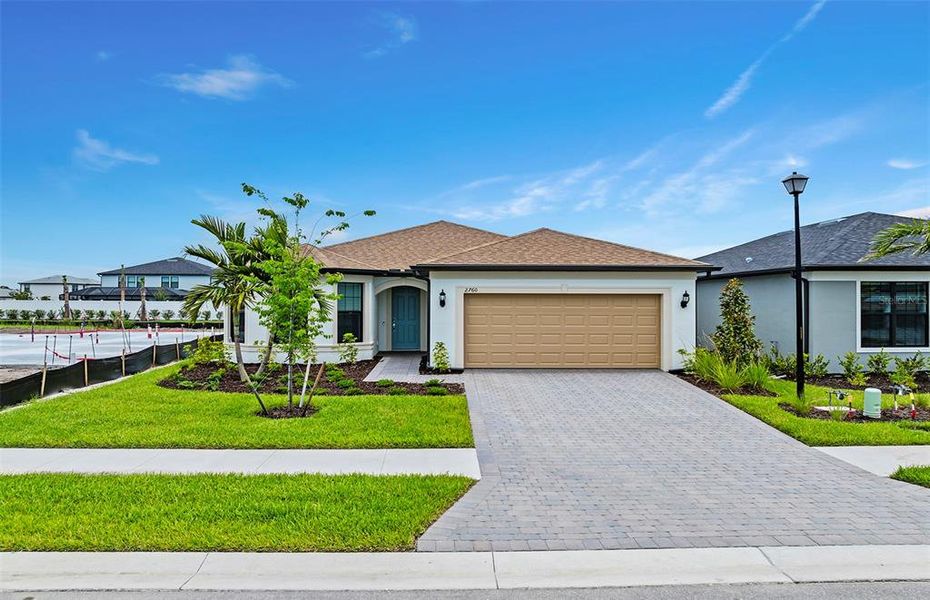 Front exterior of a new home in , North Port, FL, highlighting curb appeal (Image 1). Front exterior of a new home in , North Port, FL, highlighting curb appeal (Image 1).
