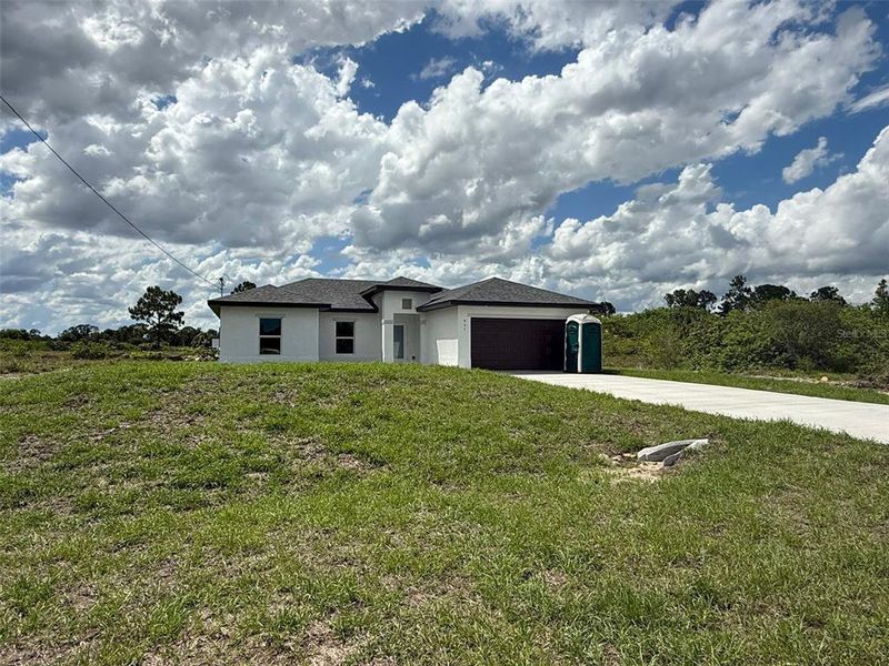 Front exterior of a new home in , Lehigh Acres, FL, highlighting curb appeal (Image 18).