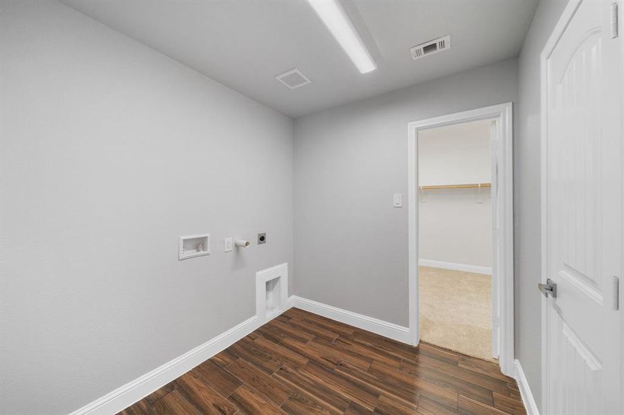 Laundry area featuring hookup for a gas dryer, dark colored carpet, hookup for an electric dryer, and washer hookup