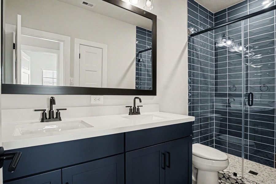 Upstairs bathroom with quartz countertop, framed mirror and upgraded hardware. Upstairs bathroom with quartz countertop, framed mirror and upgraded hardware.