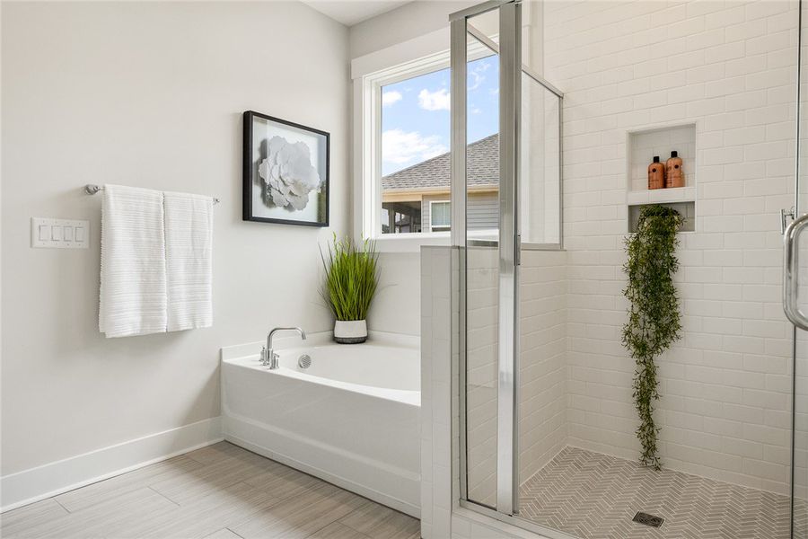 A well-lit bathroom features a deep soaking tub an A well-lit bathroom features a deep soaking tub an