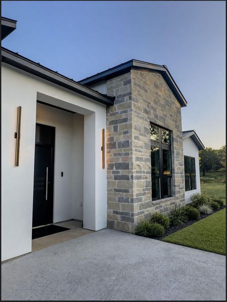 Clean lines and textured stone details define this contemporary entryway. Clean lines and textured stone details define this contemporary entryway.