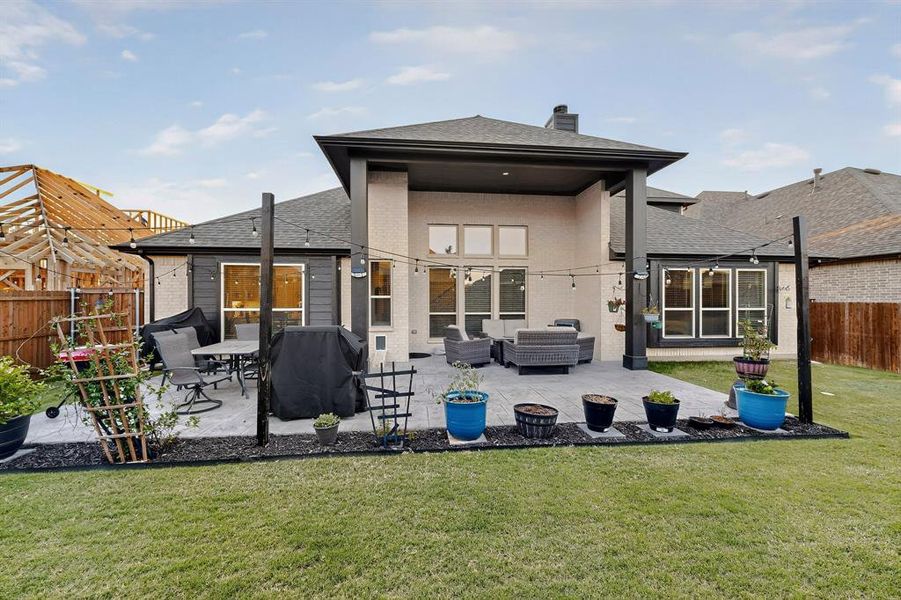 Rear view of property featuring a fenced backyard, brick siding, roof with shingles, and a chimney Rear view of property featuring a fenced backyard, brick siding, roof with shingles, and a chimney