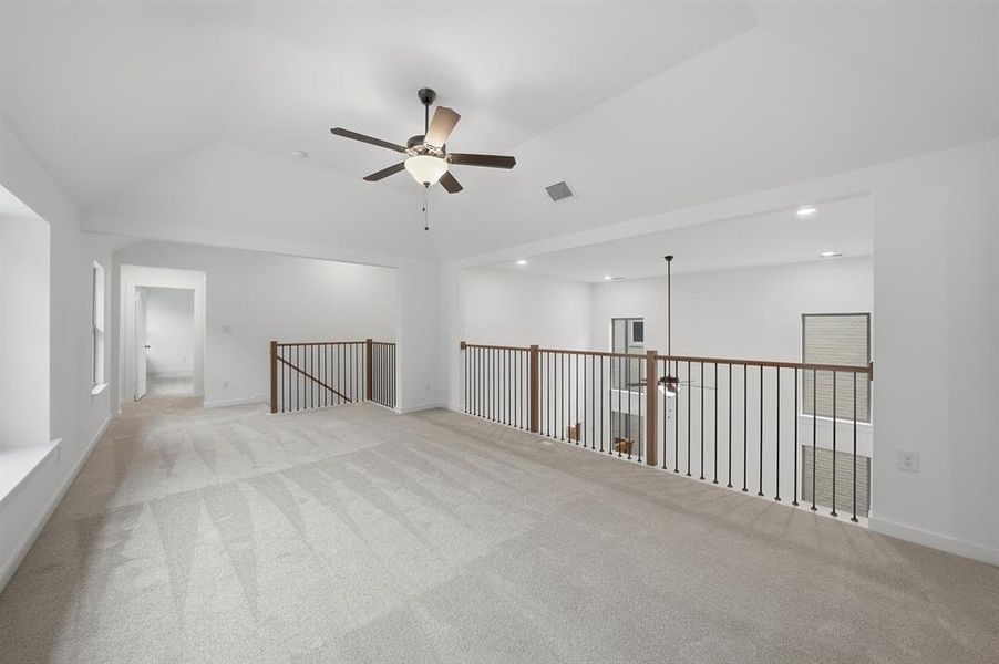 Empty room featuring ceiling fan, carpet flooring, lofted ceiling, and recessed lighting