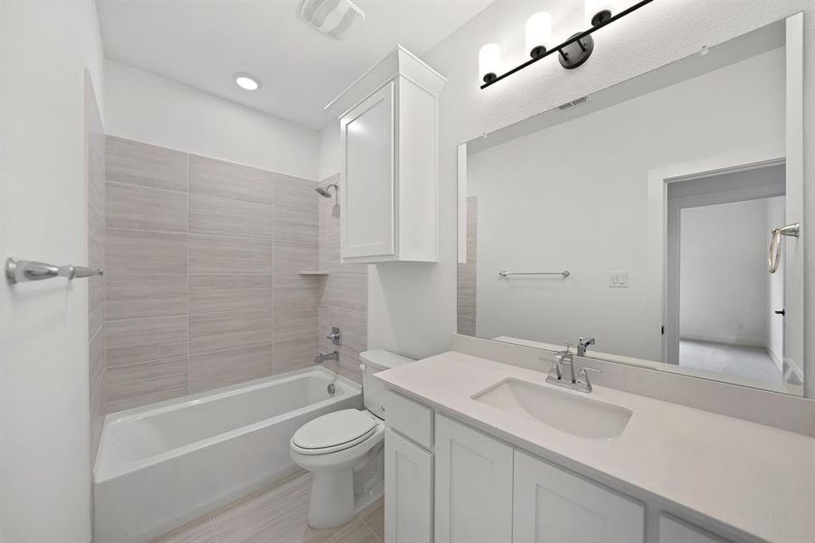 Bathroom featuring shower / washtub combination, vanity, and light tile patterned flooring Bathroom featuring shower / washtub combination, vanity, and light tile patterned flooring