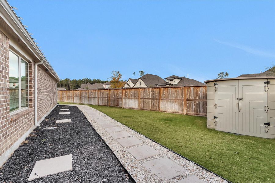 Neat side yard with storage shed
