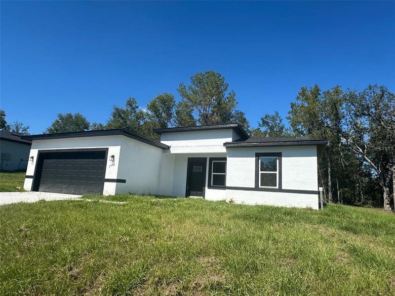 Front exterior of a new home in , Citrus Springs, FL, highlighting curb appeal (Image 29).