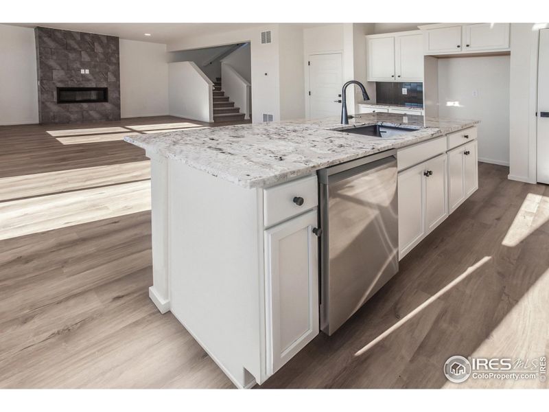 KITCHEN ISLAND OPEN TO DINING AND LIVING ROOM